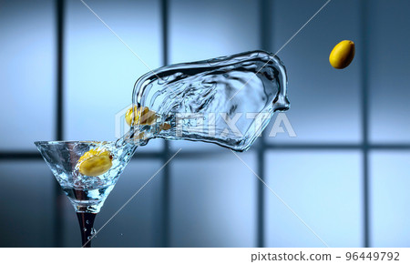 Martini and green olives in glass with splashes. 96449792