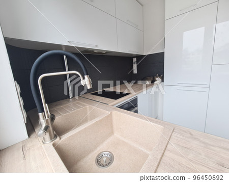 faucet in the design of a modern kitchen . faucet in the design of a modern kitchen . 96450892