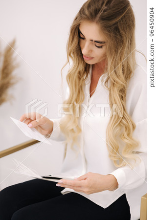 Woman open envelope and take gift card. Beauty studio. Certificate for cosmetology procedyre 96450904