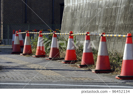 Red road cones for construction safety lined up on the road Red road cones for construction safety lined up on the road 96452134