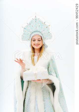 portrait of Snow Maiden in a costume with a kokoshnik with gift box on a white. 96452429