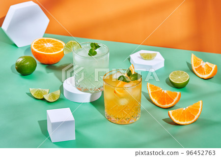 Multi-colored cocktails in glasses of different shapes on colored backgrounds with hard shadows 96452763