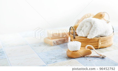 Two bars of soap, wash and massage brushes, and rolled towel. Hygienic bathroom and spa accessories. Two bars of soap, wash and massage brushes, and rolled towel. Hygienic bathroom and spa accessories. 96452792