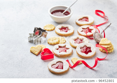 Classic Linzer Christmas Cookies with raspberry or strawberry jam on light background. Classic Linzer Christmas Cookies with raspberry or strawberry jam on light background. 96452801