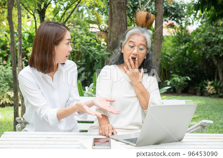 Asian daughter teaching old elderly woman use online Social media in computer laptop after retirement. Concept of Learning technology and adaptation of the elderly Asian daughter teaching old elderly woman use online Social media in computer laptop after retirement. Concept of Learning technology and adaptation of the elderly 96453090