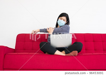 Tired woman wearing a face mask, pain in neck tensed muscles and stretch, the suffering of office syndrome after long hours work on the computer. Office syndrome and Health care concept. Tired woman wearing a face mask, pain in neck tensed muscles and stretch, the suffering of office syndrome after long hours work on the computer. Office syndrome and Health care concept. 96453091