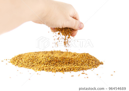 Crumbled bee pollen granules on white background. Crumbled bee pollen granules on white background. 96454689