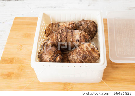 Taro placed in a heat-resistant container with cuts 96455825