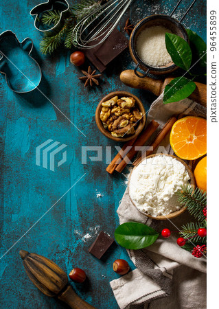 Christmas Baking background. Ingredients for Christmas baking - chocolate, cinnamon, flour, sugar, nuts, chocolate, spices on a stone or slate background. Top view flat lay background. Copy space. 96455899