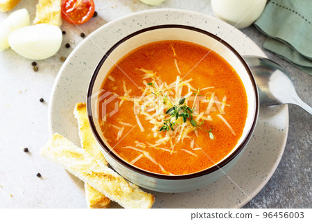 Puree soup tomato with croutons and cheese in a bowl on a light slate background. The concept of healthy eating. Diet menu. Copy space. 96456003