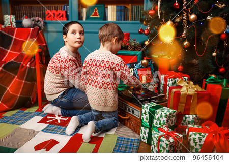 Kids decorating Christmas tree. Children at Christmas tree on Xmas eve 96456404