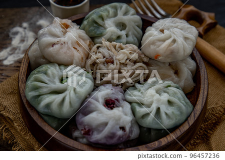 Close-up of Chinese chives Dumplings Mixed Color or Garlic Chives Dim Sum Rice Cake inside with Taro Slice ,Bamboo shoot and Many kind of vegetable inside the flour, Steamed Served Sweet Black Soy Close-up of Chinese chives Dumplings Mixed Color or Garlic Chives Dim Sum Rice Cake inside with Taro Slice ,Bamboo shoot and Many kind of vegetable inside the flour, Steamed Served Sweet Black Soy 96457236