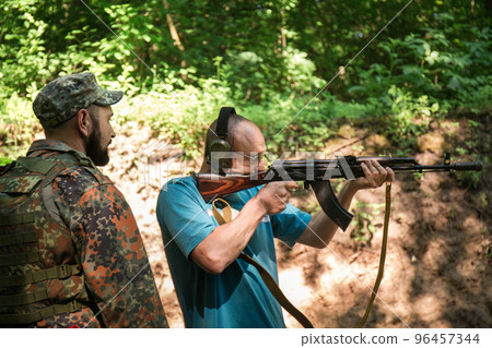 A Ukrainian civilian man is training to shoot A Ukrainian civilian man is training to shoot 96457344