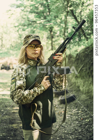 Ukrainian military woman with a machine gun in the hands Ukrainian military woman with a machine gun in the hands 96457353