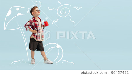 Creative design with drawn elements. Portrait of stylish little boy, child posing over blue background. dreaming about summer vacation 96457431
