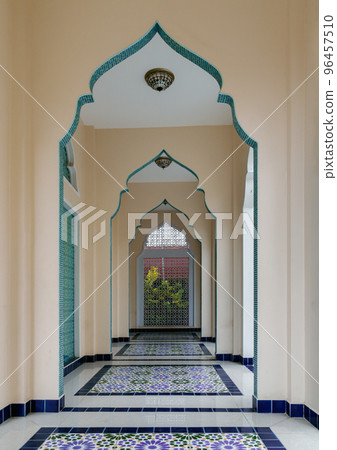 Diminishing perspective interior view of inner Bang O mosque hallway leading into blue wall. Diminishing perspective interior view of inner Bang O mosque hallway leading into blue wall. 96457510