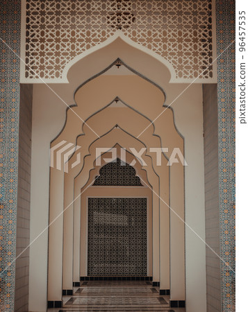 Diminishing perspective interior view of inner Bang O mosque hallway leading into blue wall. Diminishing perspective interior view of inner Bang O mosque hallway leading into blue wall. 96457535