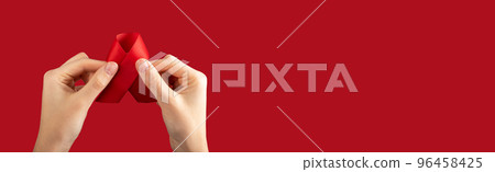 HIV red ribbon in hands on ad banner, background with copy space for text 96458425