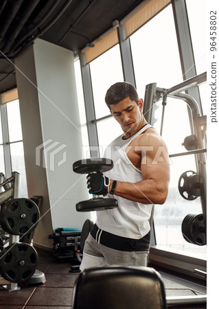 Close up of man using dumbbell exercise at gym, Sport concept 96458802