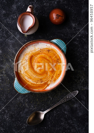 baked pumpkin cream coup with  coconut milk served in nice bowl at wooden black table. flat lay. cooking and healthy life concept 96458957