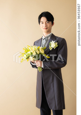 A groom with a bouquet A groom with a bouquet 96458987