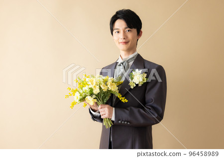 A groom with a bouquet 96458989