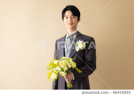 A groom with a bouquet A groom with a bouquet 96458993
