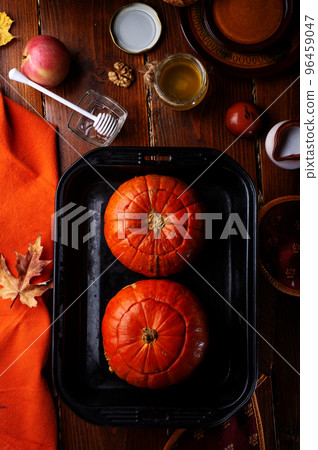 baked pumpkin cream coup served in pumpkins. served at wooden brown table. cooking recipe. flat lay. healthy life concept baked pumpkin cream coup served in pumpkins. served at wooden brown table. cooking recipe. flat lay. healthy life concept 96459047