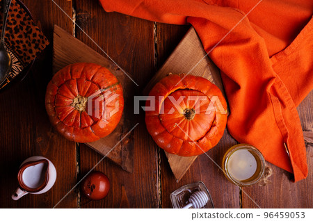 baked pumpkin cream coup served in pumpkins. served at wooden rural brown table. cooking recipe. healthy life concept baked pumpkin cream coup served in pumpkins. served at wooden rural brown table. cooking recipe. healthy life concept 96459053