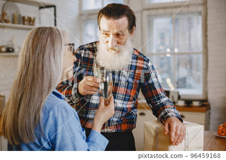 Age and people concept . Senior couple at home. People with champagne. 96459168