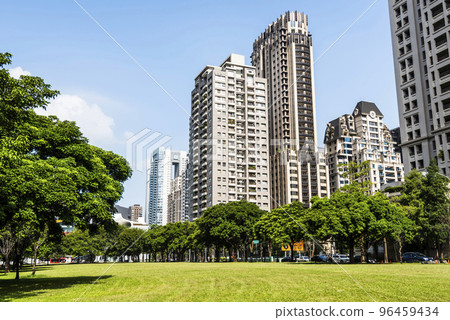 Low-angle view of green park space and modern buildings on both sides in downtown Taichung, Taiwan. here is near the National Taichung Theater. 96459434