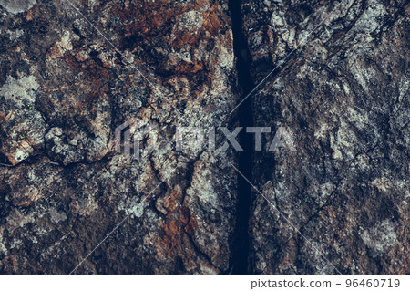 Crack in the rock on mountain in light blue tone. 96460719