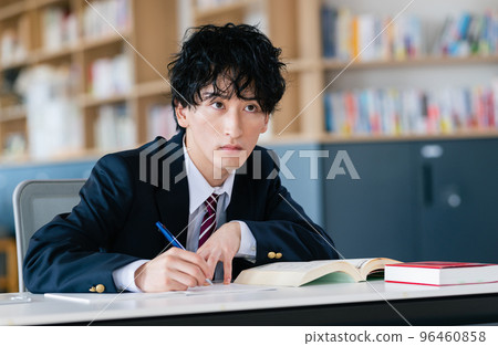 Male high school student studying for exam 96460858