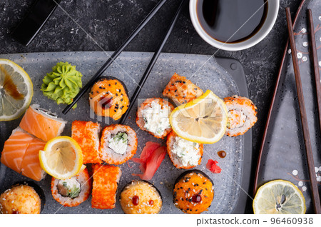 sushi roll set served at grey tray at black table. flat lay. sushi roll set served at grey tray at black table. flat lay. 96460938