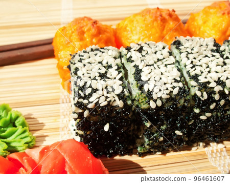 rolls with black roe and sesame and baking sushi on bamboo mat rolls with black roe and sesame and baking sushi on bamboo mat 96461607