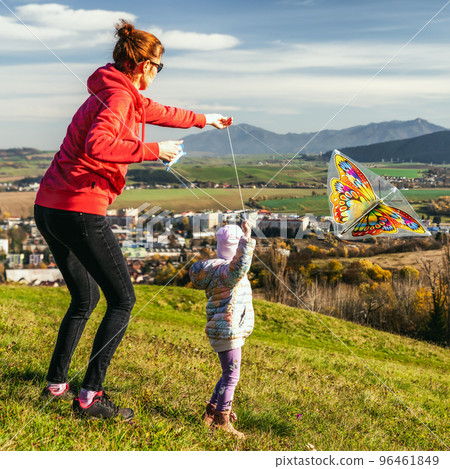 happy family mother and girl child launch a kite on meadow happy family mother and girl child launch a kite on meadow 96461849