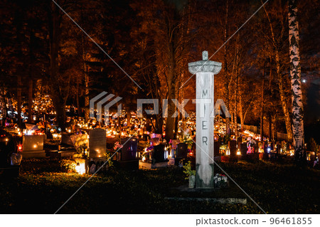 Candle lights on graves and tombstones in cemetery at night on All Souls Day Candle lights on graves and tombstones in cemetery at night on All Souls Day 96461855