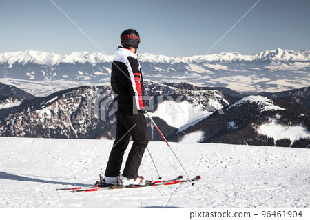 Skier on top of the hill Chopok in Low Tatras looking on snowy High Tatras mountains in Slovakia Skier on top of the hill Chopok in Low Tatras looking on snowy High Tatras mountains in Slovakia 96461904