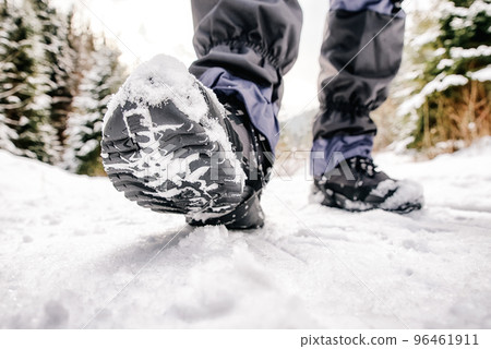 Hiking boots in snowy forest. WInter hiking 96461911
