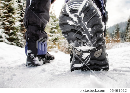 Hiking boots in snowy forest. WInter hiking 96461912