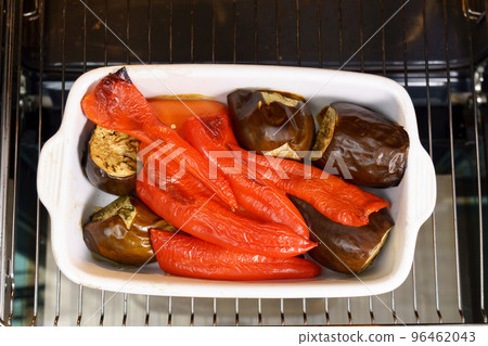 Preparing red peppers and eggplant for pepper sauce, ajvar, a traditional serbian dish. Selective focus 96462043