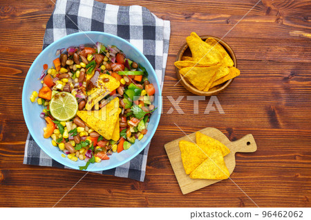 Salad texas caviar. Vegetable dish with corn, beans, pepper, pepper, tomatoes, beans. Served with corn chips nachos Salad texas caviar. Vegetable dish with corn, beans, pepper, pepper, tomatoes, beans. Served with corn chips nachos 96462062