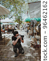 Smart young man traveller knees sitting and using his camera take a photo in street market 96462162