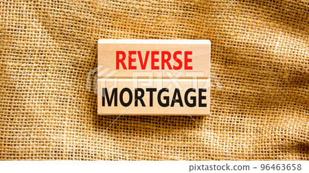 Reverse mortgage symbol. Concept words Reverse mortgage on wooden blocks. Beautiful canvas table canvas background. Business and reverse mortgage concept. Copy space. 96463658