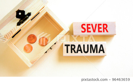 Sever trauma symbol. Concept words Sever trauma on wooden blocks. Beautiful white table white background. Wooden chest with coins. Psychological and sever trauma concept. Copy space. 96463659