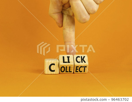 Click and collect symbol. Concept words Click and Collect on wooden cubes. Businessman hand. Beautiful orange table orange background. Click and collect and business concept. Copy space. Click and collect symbol. Concept words Click and Collect on wooden cubes. Businessman hand. Beautiful orange table orange background. Click and collect and business concept. Copy space. 96463702