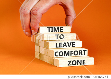 Leave comfort zone symbol. Concept words Time to leave comfort zone on wooden blocks. Businessman hand. Beautiful orange background. Business time to leave comfort zone concept. Copy space. Leave comfort zone symbol. Concept words Time to leave comfort zone on wooden blocks. Businessman hand. Beautiful orange background. Business time to leave comfort zone concept. Copy space. 96463741