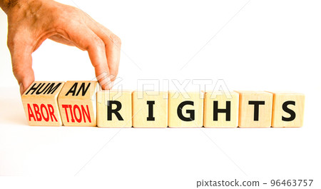 Abortion rights symbol. Concept words Abortion rights are human rights on wooden cubes. Businessman hand. Beautiful white table white background. Business medical abortion rights concept. Copy space. 96463757