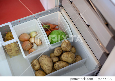Storing vegetables in the kitchen. Storing vegetables in the kitchen. 96463899