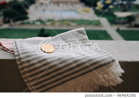 Bitcoin Coin Lies On Beach Towel On Background Of Hotel Swimming Pool In Moraitika, Corfu, Greece. The Concept Of Payment For Relax And Unlimited Possibilities. Bitcoin Coin Lies On Beach Towel On Background Of Hotel Swimming Pool In Moraitika, Corfu, Greece. The Concept Of Payment For Relax And Unlimited Possibilities. 96464298
